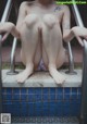 A woman sitting on the edge of a swimming pool.